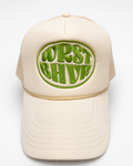 Cream Trukas WRST BHVR trucker hat with olive embroidered logo, foam front, mesh back, made in LA