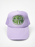 Lavender Trukas WRST BHVR trucker hat with green embroidered logo, foam front, mesh back, made in LA