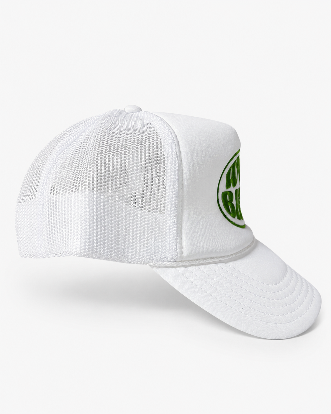Angled view of Trukas Worst Behavior trucker hat in white and lime green